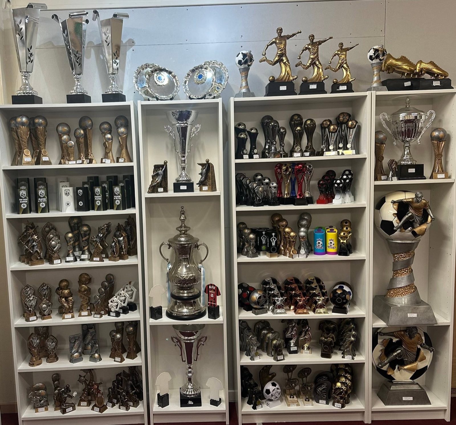 Wall of trophy display shelves inside Morgan Sports
